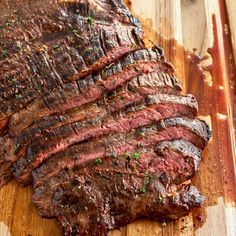 a piece of steak on a wooden cutting board