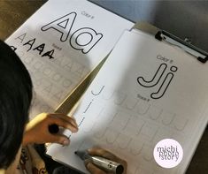 two children are doing their own handwriting work on paper with scissors in front of them