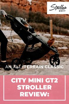 a woman pushing a stroller with the text city mini gt2 stroller review