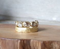 a close up of a gold ring on a wooden surface