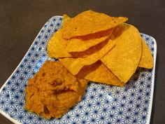 tortilla chips and salsa on a blue and white plate