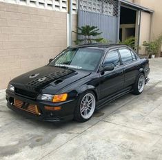 a black car parked in front of a building