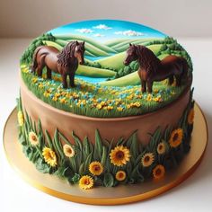 a cake decorated with two horses in a field of sunflowers and daisies