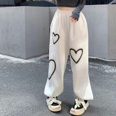 Stay cozy and stylish in our Heart Printed Sweatpants. Made from a soft and comfortable fabric, these sweatpants are perfect for lounging around the house or running errands. The playful heart print adds a touch of fun to your athleisure look. Featuring a drawstring waist and elastic cuffs, these sweatpants are designed for a customized and secure fit. Available in a range of sizes, these sweatpants are a must-have for anyone looking to add a pop of personality to their casual wardrobe. Hip Hop Cargo Pants, Baggy Pants Women, Streetwear Sweatpants, Hip Hop Women, Baggy Streetwear, Hip Hop Pants, Baggy Sweatpants, Women Cargo Pants, Streetwear Hip Hop