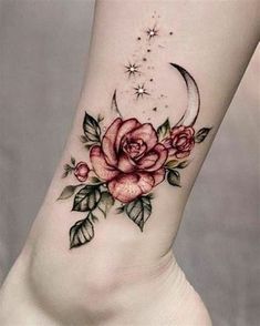 a rose and crescent tattoo on the side of a woman's leg with stars