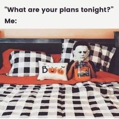 a bed with black and white checkered sheets, pillows and a pillow that says what are your plans tonight? me