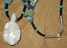 "An Original 1970's Running Bear Shop Signed Boulder Ribbon Turquoise & Sterling Necklace. Visit this shop for a wide variety of Vintage Quality Jewelry, Art, Photos and Collectibles. ~Age (approximate): 1970's ~Material(s): Turquoise & Sterling ~Approx. Size: necklace measures 15\" long & Pendant measures 2 1/4\" long ~Approx. Weight: N/A ~Signature / Brand: Signed. There is a pendant on the clasp that is marked R. B. (Inside A Bear) Sterling. ~Condition: Excellent. Clasp A Bit Tarn Running Bear, Bear Shop, Sterling Necklaces, Long Pendant, Cat Wall, Shop Signs, Quality Jewelry, 1970s, Turquoise Necklace