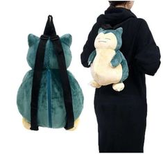 a woman wearing a hoodie and carrying a backpack with a cat stuffed animal on it