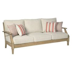 a white couch with red and orange pillows on top of it's back end