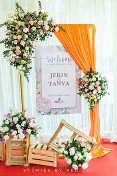 an orange and white wedding backdrop with flowers