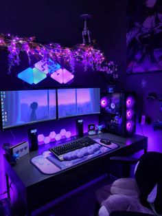 a computer desk with purple lights in the background and two monitors on it's sides