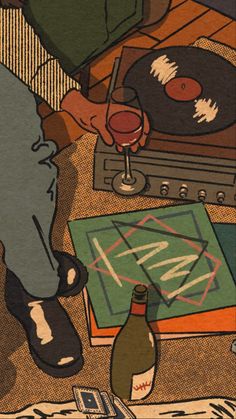 a person sitting at a table with a record player and wine glass in front of them