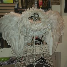 an angel's wings are attached to a wire basket