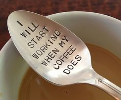 a spoon with writing on it sitting in a white bowl next to a black and white background