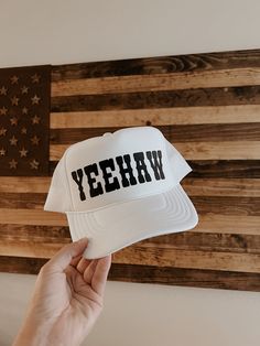 "White high crown snapback trucker hat detailed with black western \"YEEHAW\" graphic. Perfect for summer days by the pool, river, lake, and country festivals/concerts!" Country Style Summer Trucker Hat With Curved Brim, Country Style Curved Brim Trucker Hat For Summer, Western Style Snapback Hat With Curved Brim For Summer, Country Style Snapback Hat For Summer, Country Style Snapback Baseball Cap For Summer, Country Style Summer Snapback Baseball Cap, Western Style Snapback Hat For Summer, Western Style Trucker Hat For Summer Outdoor, Summer Country Style Snapback Baseball Cap