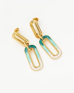 Enamel Haze Ombre Ovate Drop Hoop Earrings 18ct Gold Plated/White & Teal. These Statement Drop Link Hoops Feature Ultra-Unique Ombré Enamel Detailing, a Spectrum of Luminescent White, Aqua, and Teal. Let Them Dangle Solo or Style with Mini Hoops and Studs for an Instant Ear Stack. Metal: 18Ct Recycled Gold Plating on Brass Materials: White, Aqua and Teal Enamel Gradient Dimensions: 46. 40mm X 13. 50mm Weight: 11. 4g All the Enamel is Hand Painted and Because of Its Luminescent Finish, the Colour Trendy Gold Enamel Hoop Earrings, Gold Enamel Huggie Earrings, Gold Enamel Earrings With Gemstone, Gold Enamel Dangle Hoop Earrings, Turquoise Enamel Dangle Earrings, Crafts From Recycled Materials, Ear Stack, Star Earrings Stud, Star Studs