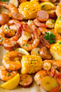 shrimp, corn on the cob and potatoes with parsley garnishes