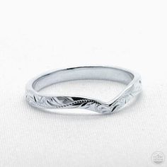 a white gold wedding band with an intricate design