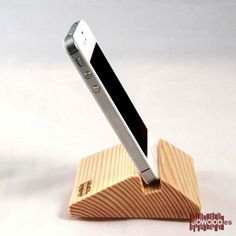 a cell phone that is on top of a wooden stand