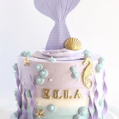 there is a cake decorated like a mermaid