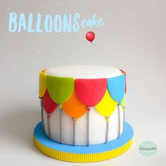 a birthday cake decorated with balloons and confetti on the top is for someone's special occasion