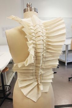 a mannequin made out of paper in a room