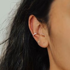 Rejoice! No piercings required to achieve the multiple-piercing look! This comfy ear cuff is easy to put on, adjustable to your ear shape, and looks so dang cute! The Nova Ear Cuff uses a thick half-round wire, making it slightly chunkier than our other ear cuffs. The Nova Ear Cuff is paired with our Classic Ear Cuff in the third photo and Double Ear Cuff in the fourth photo. Details: Two size options: 8 or 10mm depending on your ear size and where you want to wear the cuff Typically, we suggest Ear Cuffs, Ear Cuff, Diamond Earrings, Piercings, Cuff, Sterling Silver, Silver, Gold