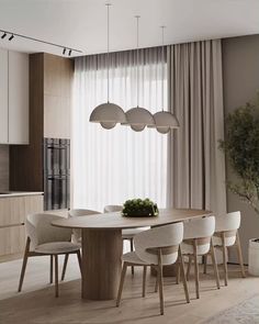 a dining room table surrounded by white chairs and hanging lights over the top of it