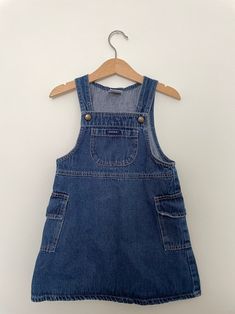 "1990's guess overall denim dress with cargo pockets. Snaps at shoulder for easy on and off. Dark denim in great condition. There are a couple small paint spots around the bottom right pocket as shown in the last two photos. Tagged a size 4.  Waist: 11 1/2\" Hip 13 1/2\" Length from shoulder: 21\"" Sleeveless Denim Shortalls With Pockets, Medium Wash Denim Overall Dress With Pockets, Casual Denim Pinafore Dress With Pockets, Vintage Sleeveless Overalls With Pockets, Overall Denim Dress, Small Paint, Dark Denim, Overall Shorts, Denim Dress