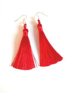 Long, bright red tassel earrings with silver plated ear hooks, boho style. Excellent for a Valentine's gift.Lovely long tassels made from cotton in a vibrant bright red colour. With silver plated ear wires.A great gift for any occasion. Total length of our red tassel earrings approximately: 11cm / 4.3" Tassel length approximately: 9cm / 3.5"Supplied with tiny stoppers to help keep the earrings in place. These need to be removed before placing the earrings in the ear and then replaced. The earrin Red Statement Earrings, Coral Drop Earrings, Spider Necklace, Long Tassel Earrings, Light Earrings, Mode Boho, Luxury Earrings, Long Fringe, Long Fringes