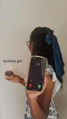 a woman holding up a cell phone in front of her face with the caption birthday girl