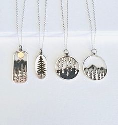 Our sterling silver pine tree charm collection is the perfect gift for the lover of the outdoors. This necklace is delicate and dainty.  Sterling Silver Moon, Mountain, Tree 33x13 mm Sterling Silver Pine Tree 22x10 mm Sterling Silver Birch Tree 26x20 mm Sterling Silver Mountain, Pine Tree 26x20 mm DETAILS & SIZE * The listing is for one pendant necklace  * Chain: sterling silver and findings * Every purchase comes in a Tangerine branded gift box. * Handcrafted with care in Seattle WA * We LOVE what we create and want you to equally LOVE your new jewelry! MATERIALS GOLD FILLED: Gold-filled is an actual layer of gold-pressure bonded to another metal. Gold filled is not to be confused with gold plating as filled literally has 100% more gold than gold plating. Gold filled is tarnish-resistant. Mt Whitney, Moon Mountain, Mountain Tree, Silver Mountain, Wanderlust Jewelry, Mountain Necklace, Nature Necklace, Tree Necklace, Silver Moon