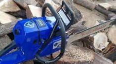 a chainsaw sitting on top of a pile of wood