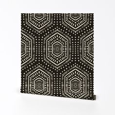 an intricate black and white pattern on a square tile wall hanging in front of a white background