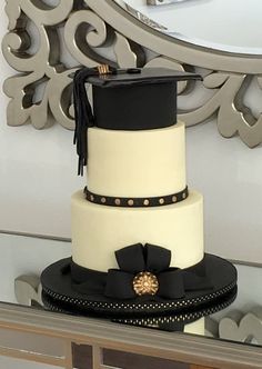 a three tiered cake sitting on top of a table in front of a mirror