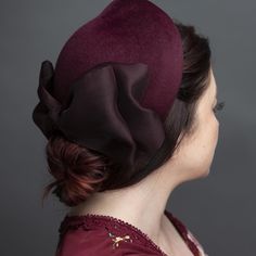 Elegant calot of merlot velour fur felt. Trimmed with a matching asymmetrical silk organza bow. Lined in pure silk. Perches gently on the back of the head. Easy and comfortable to wear with a comb and horsehair loops for pinning into place. One size fits most. Lifted Millinery headwear is constructed with time honored techniques and fine craftsmanship. All hats are meticulously blocked and sewn by hand without the use of adhesives to attach trims. This ensures a long lasting hat with the ability Millinery Diy, Head Turban, Organza Bow, Veiled Hats, Vintage Millinery, Back Of The Head, Big Hat, Millinery Hats, Vintage Hats