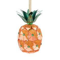 an ornament shaped like a pineapple with green leaves and orange glitters