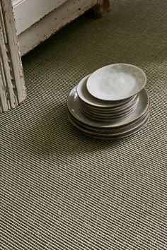 a stack of plates sitting on top of a rug