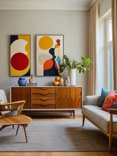 a living room filled with furniture and paintings on the wall