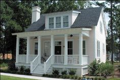 a small white house with porches and windows