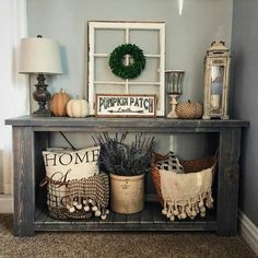 a shelf with some plants and other decorations on top of it in a living room