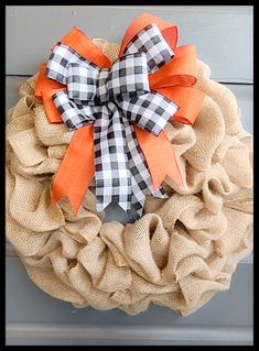 a burlock wreath with orange and black bows