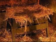 an old wooden bench covered in hay