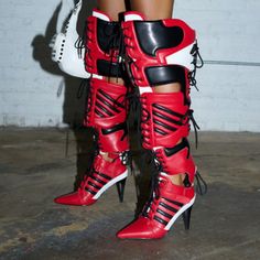 Shooters Shoot Shooters Score. Go Ahead And Shoot Your Shot In The Azalea Wang " Biker Baddie " Red Sport 2-1 Boot. Crafted From A Faux Leather Upper, This Unique 2-In-1 Boot Boasts A Color Block Patterning With Side Striped Patterning, A Slim Stiletto Heel, A Mid-Calf Shaft, Front And Back Cut Out Detailing, Lace-Up Paneling Throughout, A Velcro Foot Band Strap, And A Puffy Top Shaft. Complete With A Coordinating, Removable Thigh Piece That Can Transform The Boot Into A Thigh-High Silhouette. S Shorts And A Crop Top, Thigh Piece, Azalea Wang, Size 11 Heels, Sport 2, Boot Brands, Sporty Chic, Basketball Shorts, Thigh High Boots