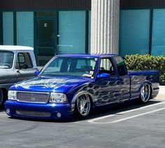 a blue truck parked in front of a building