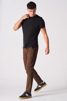 Our men's Dark Brown chino trouser is a versatile and stylish addition to any man's wardrobe. With a slim fit, tonal buttons, and welted pockets, these chinos are perfect for any occasion. Dress them up with a blazer and shirt for a sharp look, or keep them casual with a tee and sneakers. Whether you're headed to the office or out on the town, our men's chocolate brown chino trousers will have you looking your best. Order your pair today! Product Features: Dark brown twill fabric Slim fit Stretch Belt Loops Tonal buttons Button and zip fly fastening 5-pocket design 98% Cotton, 2% Elastane Our Model is 5'11 and Wears Size 32. To find the perfect fit for yourself, check our Size Guide Brown Trousers Men Outfits, Dark Brown Pants Outfit Men, Men’s Brown Chinos Outfits, Brown Pants Outfit Men, Well Dressed Men Casual, Classic Brown Relaxed Fit Chinos, Brown Relaxed Fit Straight Chinos, Slim Fit Semi-formal Chinos With Pockets, Brown Pants Men