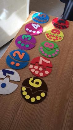 a table topped with lots of different colored numbers on top of wooden tables next to a refrigerator