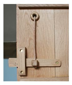 an open wooden door with a handle on it