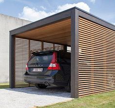 a car is parked in the garage with it's door open to allow shade