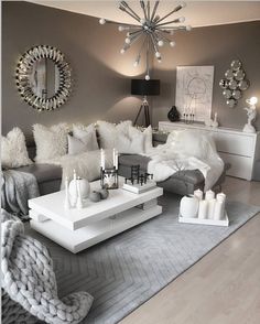 a living room filled with lots of white furniture